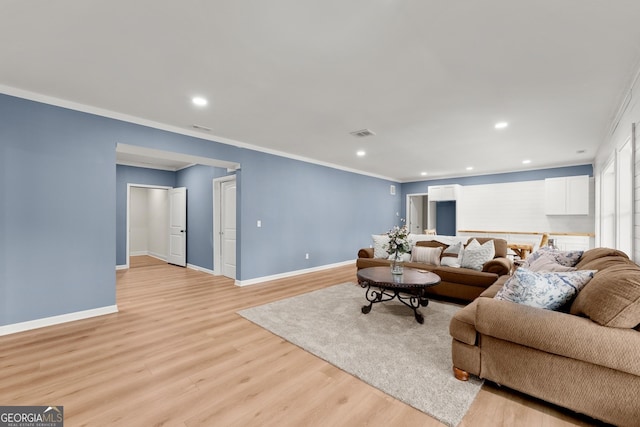 living room featuring crown molding and light wood-type flooring