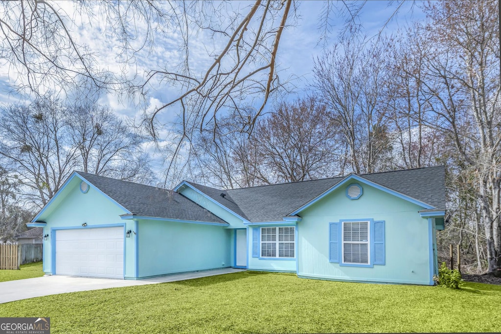 ranch-style house with a garage and a front lawn