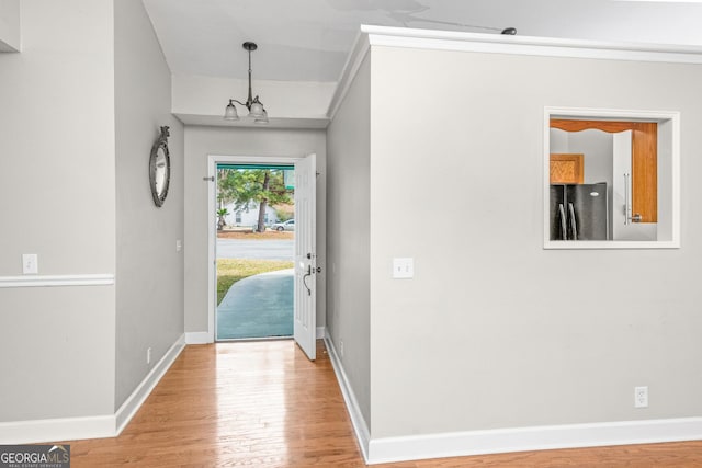 foyer featuring an inviting chandelier and wood-type flooring