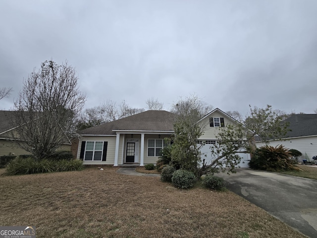 view of front of home featuring a garage and a front yard