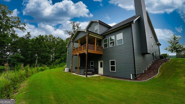 back of house with a yard and a patio area