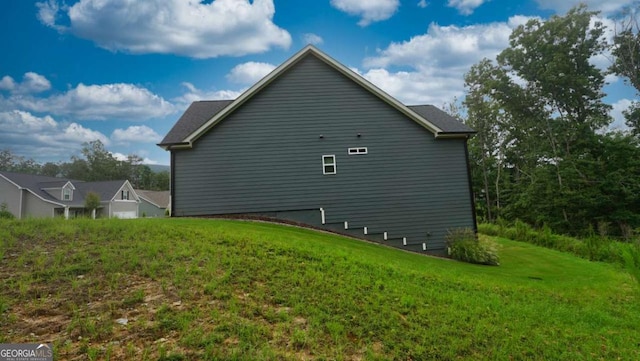 view of property exterior with a lawn