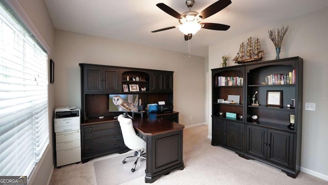 office space featuring light colored carpet and ceiling fan