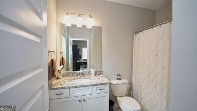 bathroom with vanity, toilet, and a shower with shower curtain