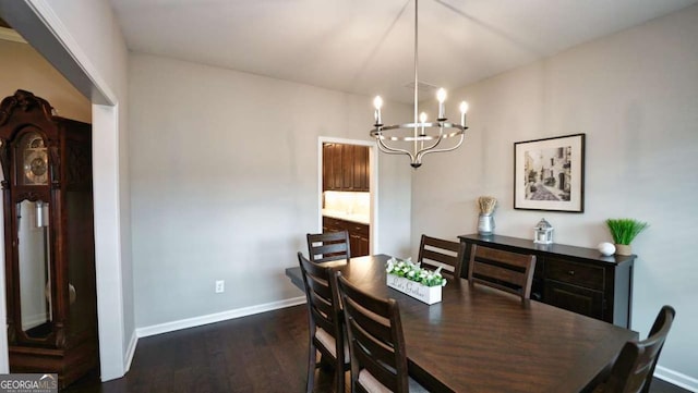 dining space featuring dark hardwood / wood-style flooring and a notable chandelier