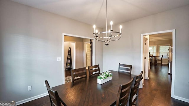 dining room with an inviting chandelier and dark wood-type flooring