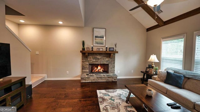 living room with ceiling fan, high vaulted ceiling, dark wood-type flooring, and a fireplace