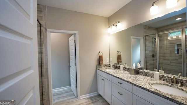 bathroom with walk in shower and vanity