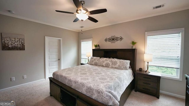 carpeted bedroom featuring crown molding and ceiling fan