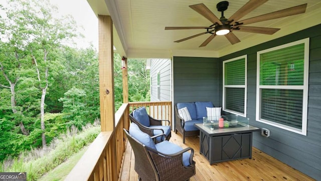 deck with an outdoor hangout area and ceiling fan