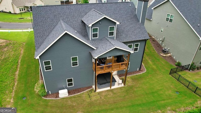 rear view of house featuring central AC, a lawn, and a patio