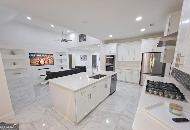 kitchen with a kitchen island with sink, appliances with stainless steel finishes, sink, and white cabinets