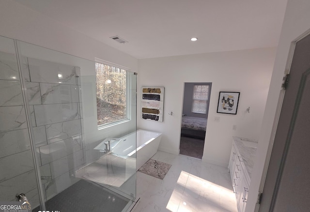 bathroom featuring vanity and a tub to relax in