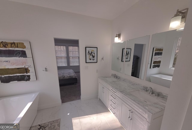 bathroom with vanity and a tub