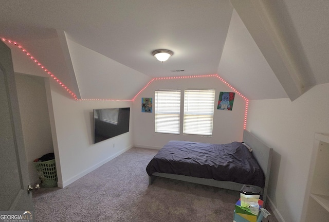 bedroom featuring vaulted ceiling and carpet