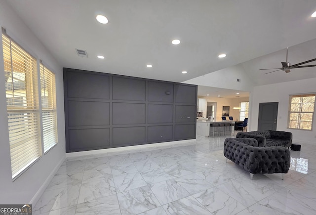 living room with vaulted ceiling and ceiling fan