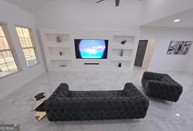 living room with built in shelves, high vaulted ceiling, and ceiling fan