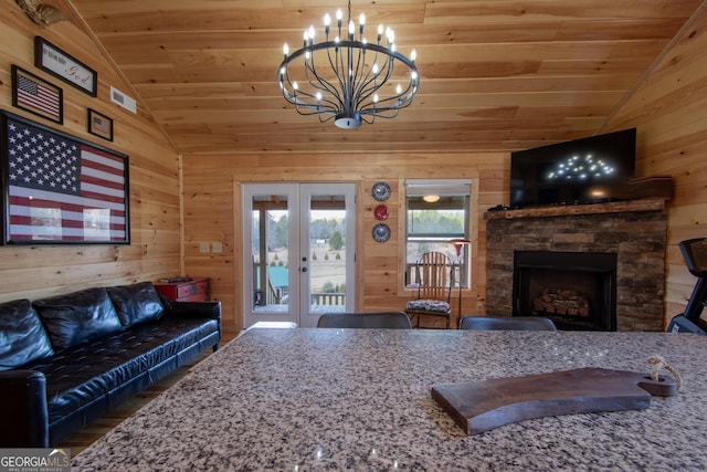 living room featuring lofted ceiling, wooden ceiling, and wood walls