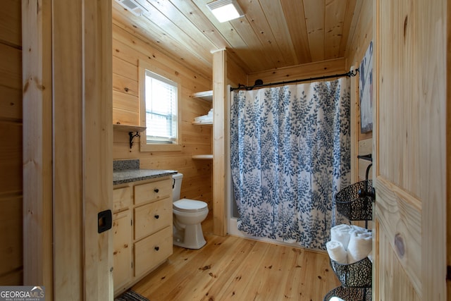 bathroom with hardwood / wood-style floors, wood walls, wooden ceiling, toilet, and walk in shower