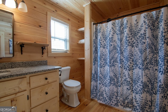 bathroom with hardwood / wood-style floors, wood walls, vanity, toilet, and wooden ceiling