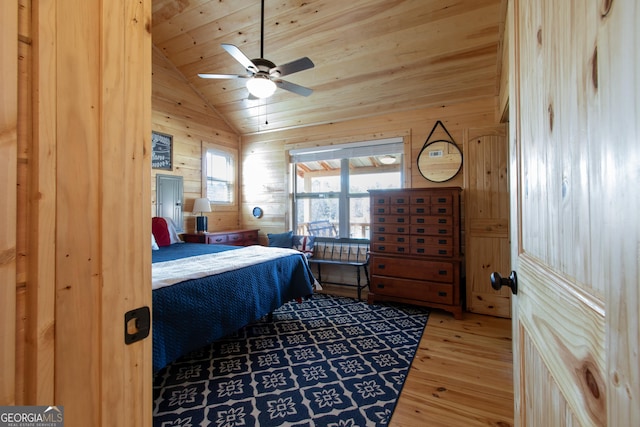 bedroom featuring lofted ceiling, wood walls, wood-type flooring, wooden ceiling, and ceiling fan