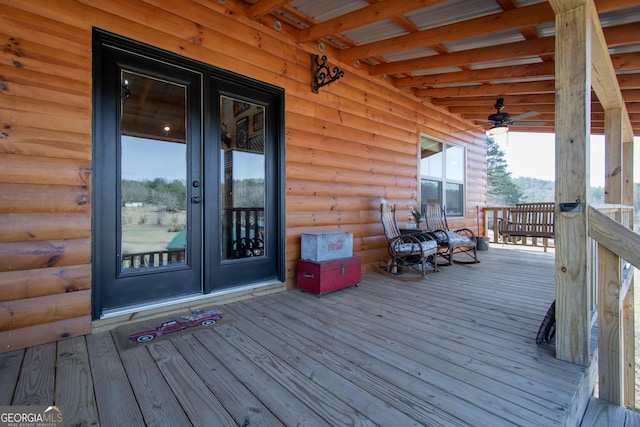 wooden terrace featuring ceiling fan and french doors