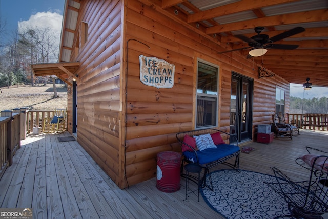 wooden terrace featuring ceiling fan