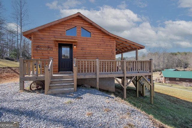 rear view of property with a wooden deck