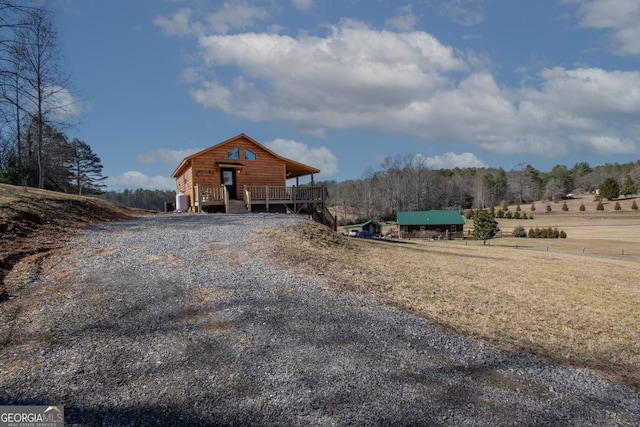 exterior space featuring a rural view and a wooden deck