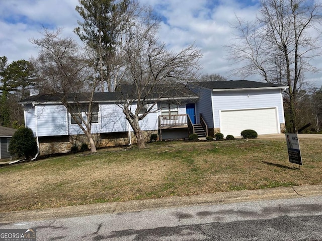 view of front of property with a garage and a front lawn