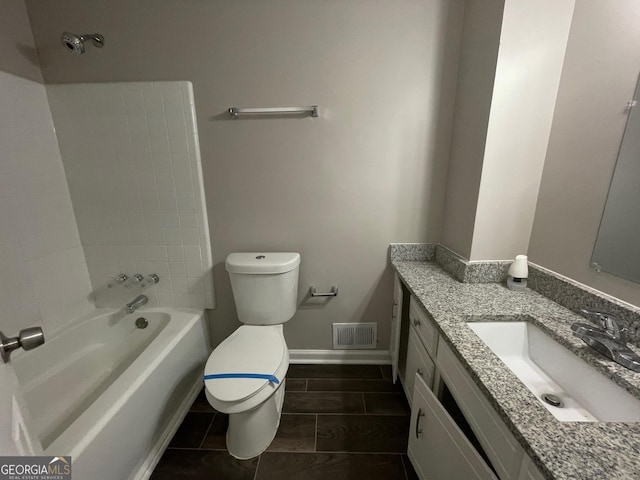 full bathroom featuring washtub / shower combination, vanity, and toilet