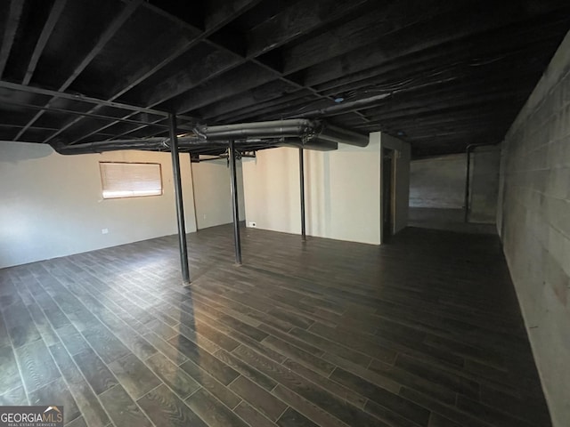 basement featuring dark hardwood / wood-style floors