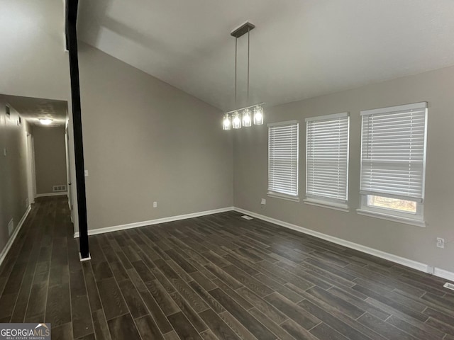 empty room featuring lofted ceiling and dark hardwood / wood-style floors