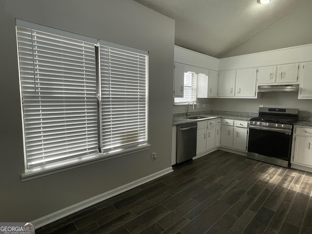 kitchen featuring appliances with stainless steel finishes, lofted ceiling, sink, white cabinets, and dark hardwood / wood-style flooring