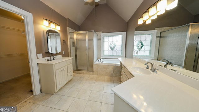 bathroom with tile patterned floors, vaulted ceiling, a shower stall, and a sink