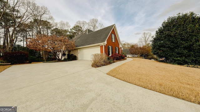 view of property exterior featuring concrete driveway and brick siding