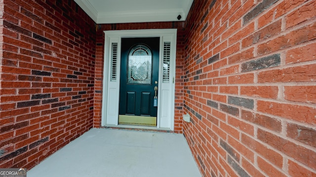 doorway to property with brick siding