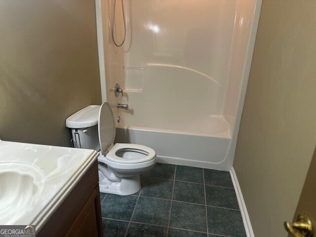 full bathroom featuring tile patterned floors, toilet, tub / shower combination, and vanity