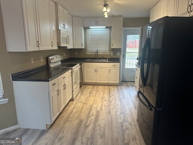 kitchen featuring white appliances, light hardwood / wood-style floors, sink, and white cabinets