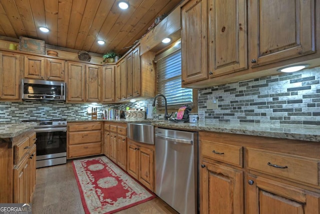 kitchen featuring light stone counters, tasteful backsplash, wooden ceiling, and appliances with stainless steel finishes