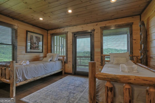 bedroom featuring wooden walls, wooden ceiling, and dark hardwood / wood-style floors