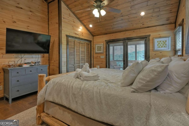 bedroom featuring lofted ceiling, hardwood / wood-style floors, wooden ceiling, and wood walls