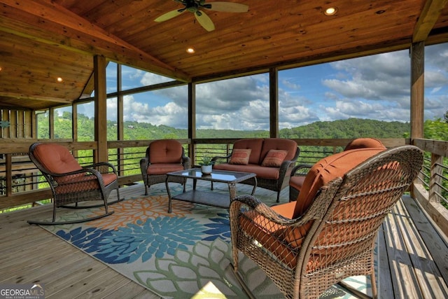 sunroom featuring lofted ceiling, wood ceiling, and ceiling fan