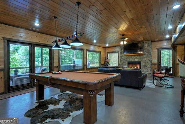 game room with wood ceiling, billiards, concrete flooring, a fireplace, and wood walls