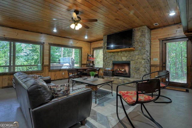 living room with plenty of natural light, wood ceiling, and wooden walls