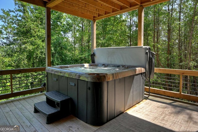 wooden deck featuring a hot tub