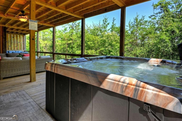 exterior space with a wealth of natural light, ceiling fan, and a jacuzzi