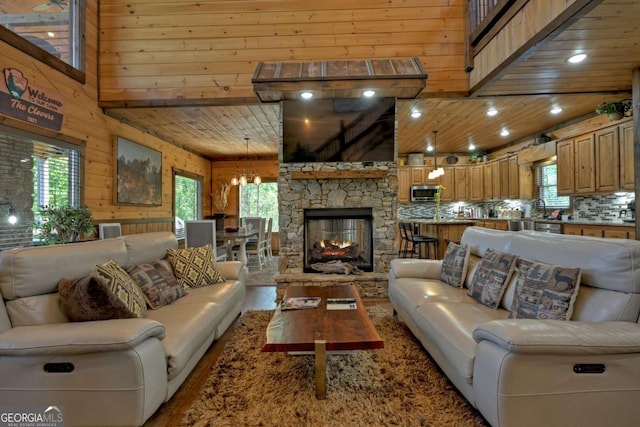 living room featuring a healthy amount of sunlight, wooden walls, and a high ceiling