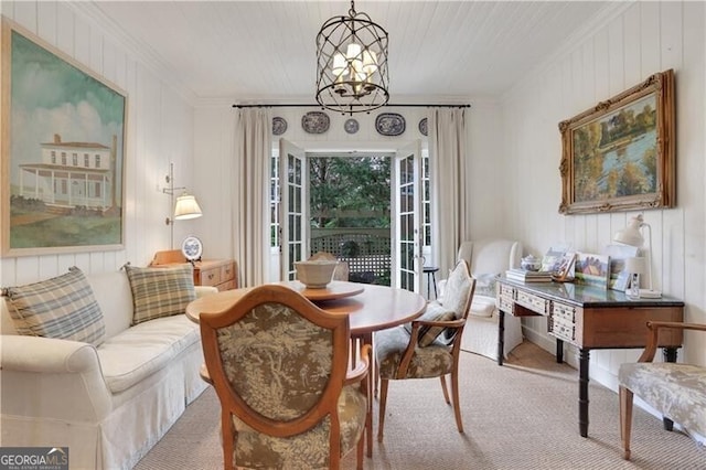 sitting room featuring ornamental molding, light carpet, and a notable chandelier