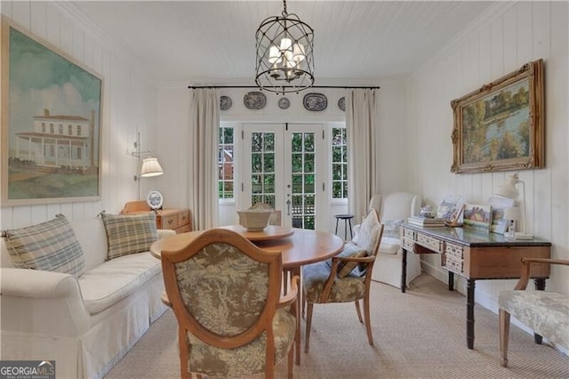 living area featuring an inviting chandelier, light colored carpet, ornamental molding, and french doors